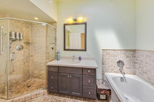 a bathroom with a tub and a sink and a shower at Spacious 2br Near Ocean & Sutro Heights Park in San Francisco