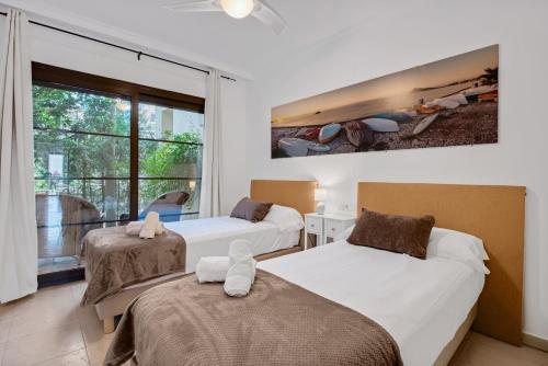 a bedroom with two beds and a large window at Villa Gadea 4-2 in Altea