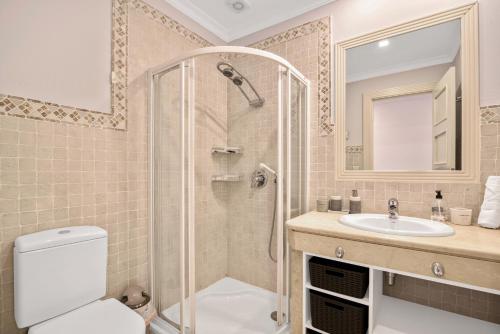 a bathroom with a shower and a toilet and a sink at Villa Gadea 4-2 in Altea