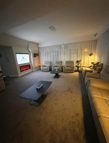 a large living room with a couch and a tv at Wild Atlantic Inn in Lisdoonvarna