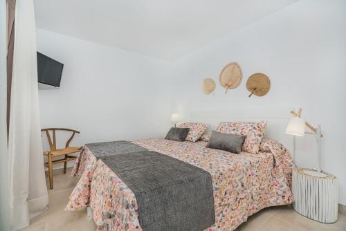 a white bedroom with a bed with pillows at Cana Ferrera in Port de Pollensa