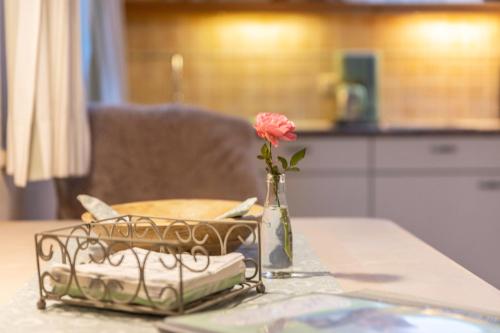 a vase with a rose in it on a table at Ferienwohnung Zwiesel in Wackersberg