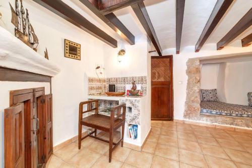 a kitchen with a table and a chair in a room at Cas Mariner Puerto de Sóller in Port de Soller