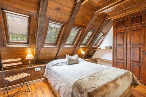 a bedroom with a bed in a room with wooden walls at Casa aranesa en centro de Arties in Arties