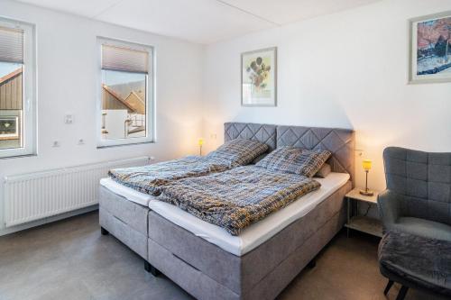 a bedroom with a bed and a chair at Apartment auf dem Land in Einbeck