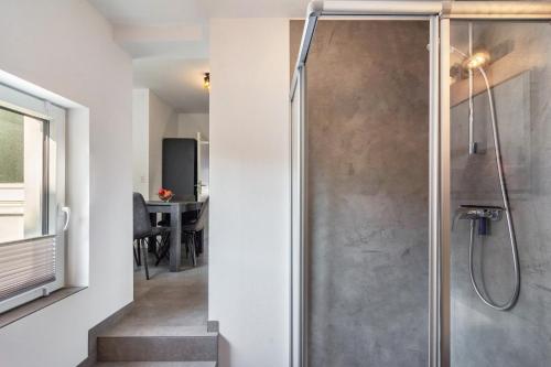 a shower with a glass door in a bathroom at Apartment auf dem Land in Einbeck