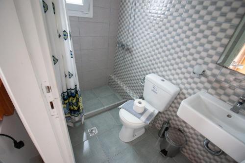 a bathroom with a toilet and a sink at Nikiana Sailing Beach Club in Nikiana