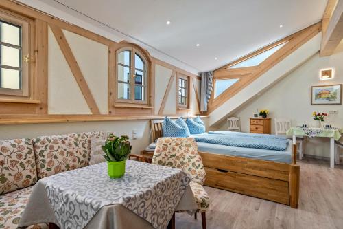 a bedroom with a bed and a table and chairs at Altstadtidyll Meißen in Meißen