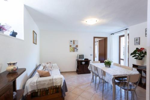 a living room with a table and a couch at Casa Rita app 4 A in Tremosine Sul Garda