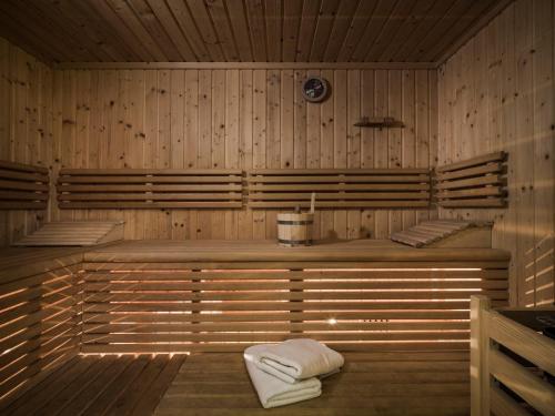 a sauna with towels sitting in a wooden room at Chalet Wolfbachgut in Taxenbach