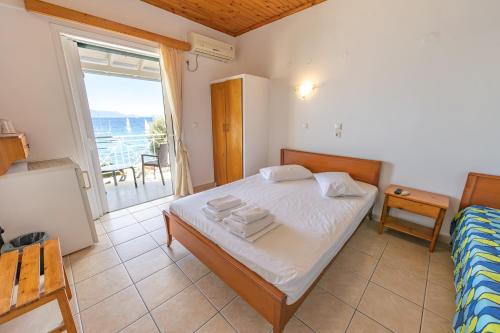 a bedroom with a bed and a view of the ocean at Nikiana Sailing Beach Club in Nikiana