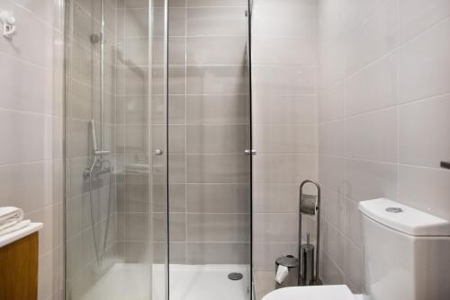 a bathroom with a shower and a toilet at A O - Apartamento Gâmboa in Peniche