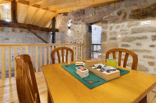 a wooden table with chairs and a box on it at Casa da Marquinhas - Turismo Rural in Lama de Ouriço