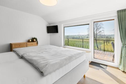 a bedroom with a bed and a large window at Fewo Bergfeld in Mosbach