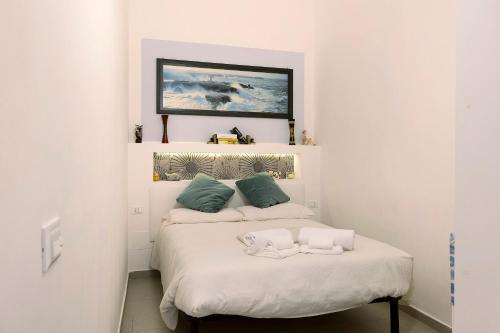 a bedroom with a bed with two pillows on it at Smart Home Loano in Loano