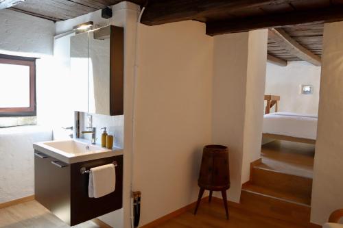 a bathroom with a sink and a bunk bed at Casa Elena Rustico storico a Corippo in Corippo