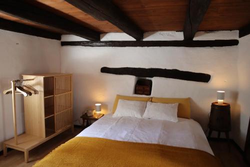 a bedroom with a bed and a wooden ceiling at Casa Elena Rustico storico a Corippo in Corippo