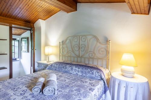 a bedroom with a bed with towels on it at Domino Cottage - Monteggiori in Camaiore