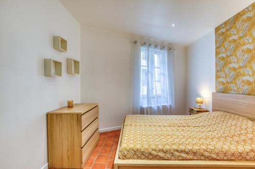 a bedroom with a bed and a window at La Reine in Béziers
