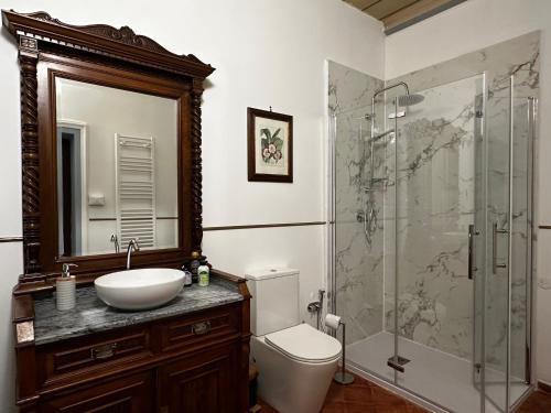 a bathroom with a toilet and a sink and a shower at Villa Amore Tuscany in Capannori