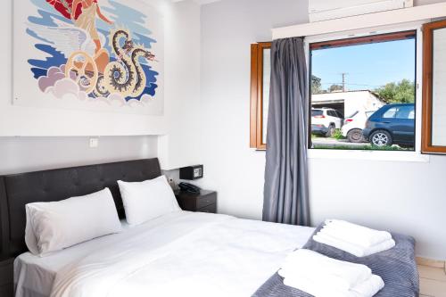a bedroom with a bed and a window at Anemi Leros Apartments 1 in Panteli