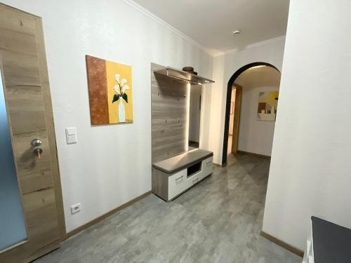 a bathroom with a sink and a painting on the wall at Wiesenblick in Brilon