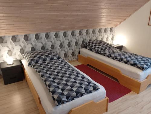two twin beds in a room with two tables at Wiesenblick in Brilon