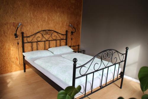 a bedroom with a bed with a metal headboard at Ferienwohnung Klint 2 in Dellstedt