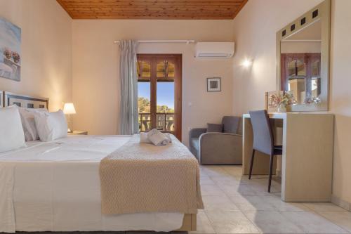 a bedroom with a large bed and a living room at Dimaras Apartments Zakynthos in Vasilikos