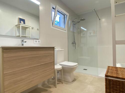 a bathroom with a shower and a toilet and a sink at Can Botana 3 in Cala de Sant Vicenc