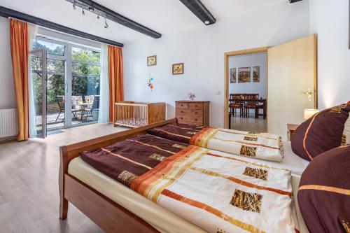 a bedroom with a large bed in a room at Ferienwohnungen zur Reuse in Mardorf