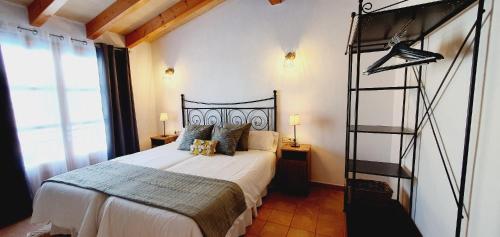 a bedroom with a large bed with a metal ladder at Casa s’Hort - Can Rita in Llombarts