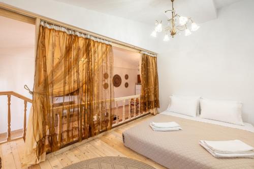 a bedroom with a bed and a large window at Absinthia Fanes in Rhodes Town