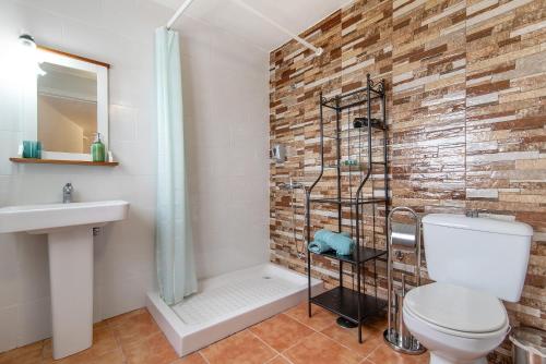 a bathroom with a shower and a toilet and a sink at Casa Verol B in Moya