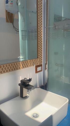 a bathroom with a white sink and a mirror at casa glamping in Lunahuaná