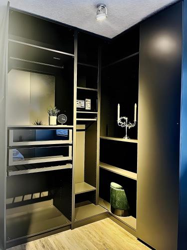 a walk in closet with black walls and wooden floors at Ferienwohnung Stern in Goslar