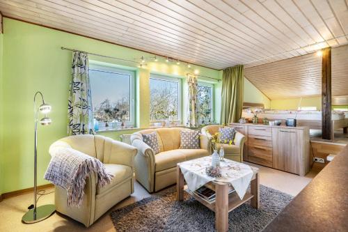 a living room with two couches and a bed at Fluss aufwärts in Schülp