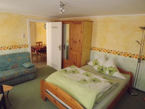 a bedroom with a bed and a living room at Ferienwohnungen Sonnenblumenhaus in Bamberg