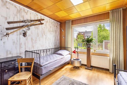 a bedroom with a bed and a window at Happy Place Indu Style in Korbach