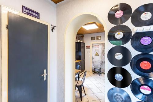 a room with a bunch of records on the wall at Happy Place Indu Style in Korbach