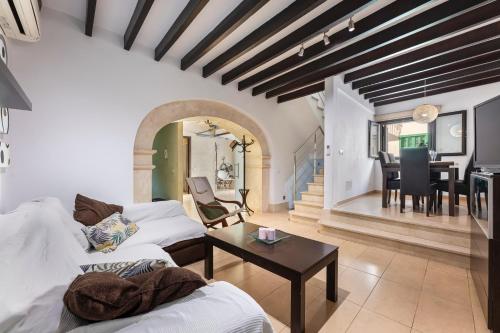 a living room with a couch and a table at Casa típica mallorquina en Sa Pobla in Sa Pobla
