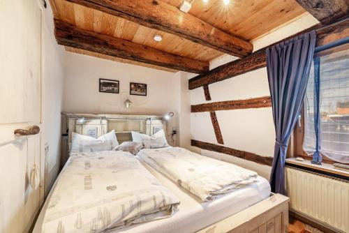 a large bed in a room with wooden ceilings at Schuler-Haus in Balingen