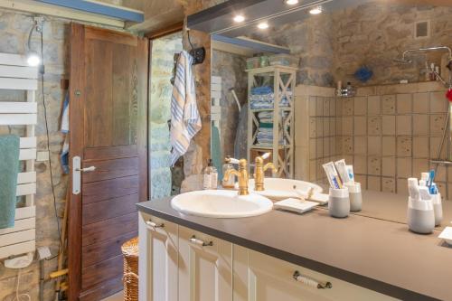 a bathroom with a sink and a mirror at Villa L'Elzède in Les Vans
