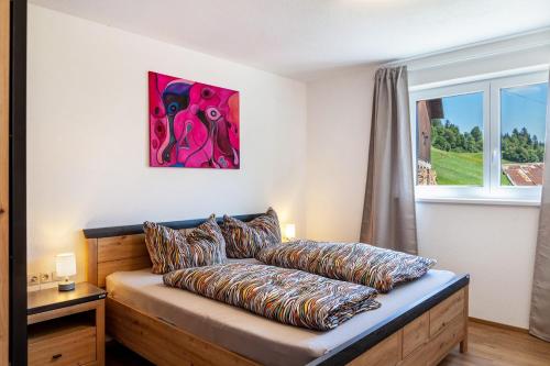 a couch with pillows on it in a room with a window at Manu's Bergblick in Arzl im Pitztal