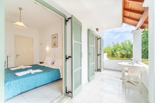 a bedroom with a bed and a bathroom with a sink at Olivea Studio 2 in Acharavi