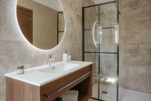 a bathroom with a sink and a mirror at Villa Lapidea in Bezjaki