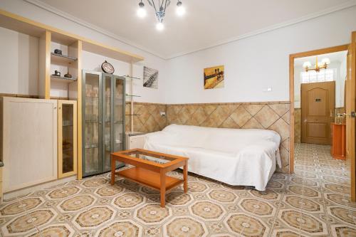 a bedroom with a bed and a table at Geranio in Caserío Bacarot