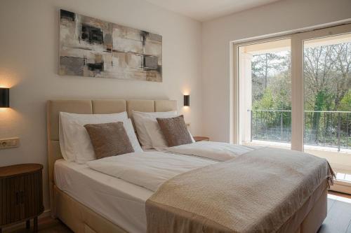 a large bed in a bedroom with a window at Villa Lapidea in Bezjaki