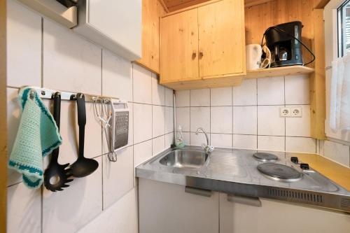a kitchen with a sink and a counter top at Bungalow 37b - Kimbucht in Reichendorf