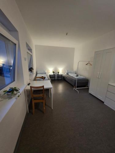 a living room with a table and a bed at Relax after work in Ochsenhausen